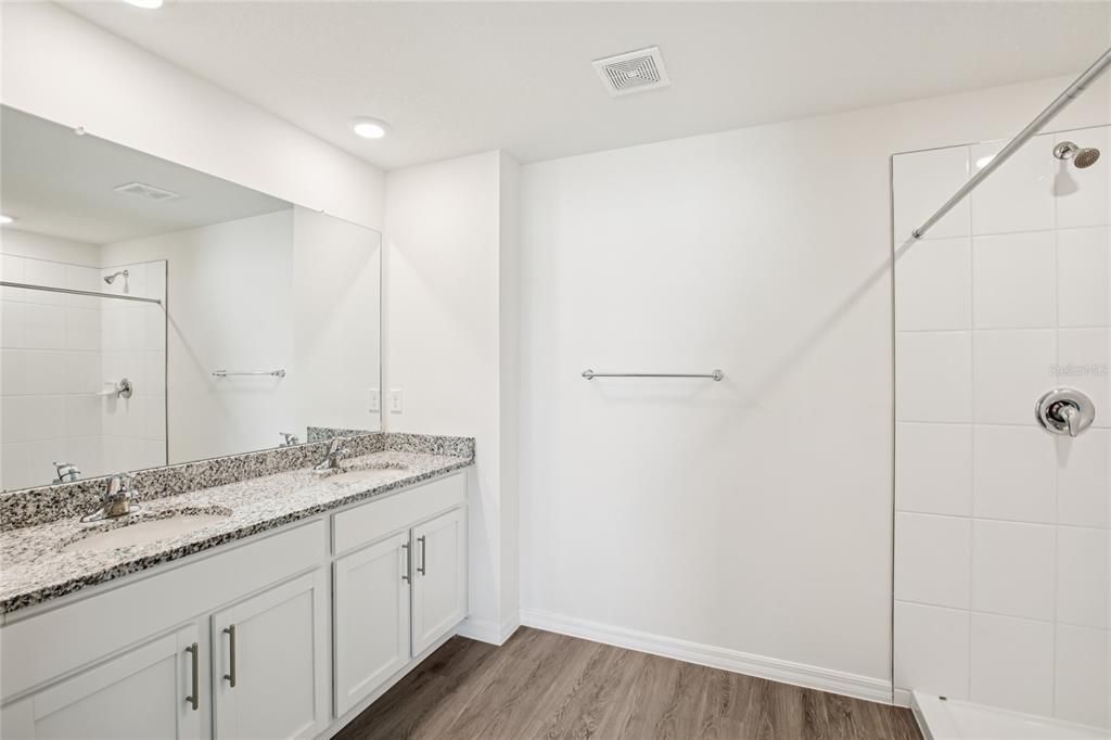 Bathroom, Dual Sink Vanities, Glass Shower, Interior, Recessed Lighting, Wood Texture Flooring