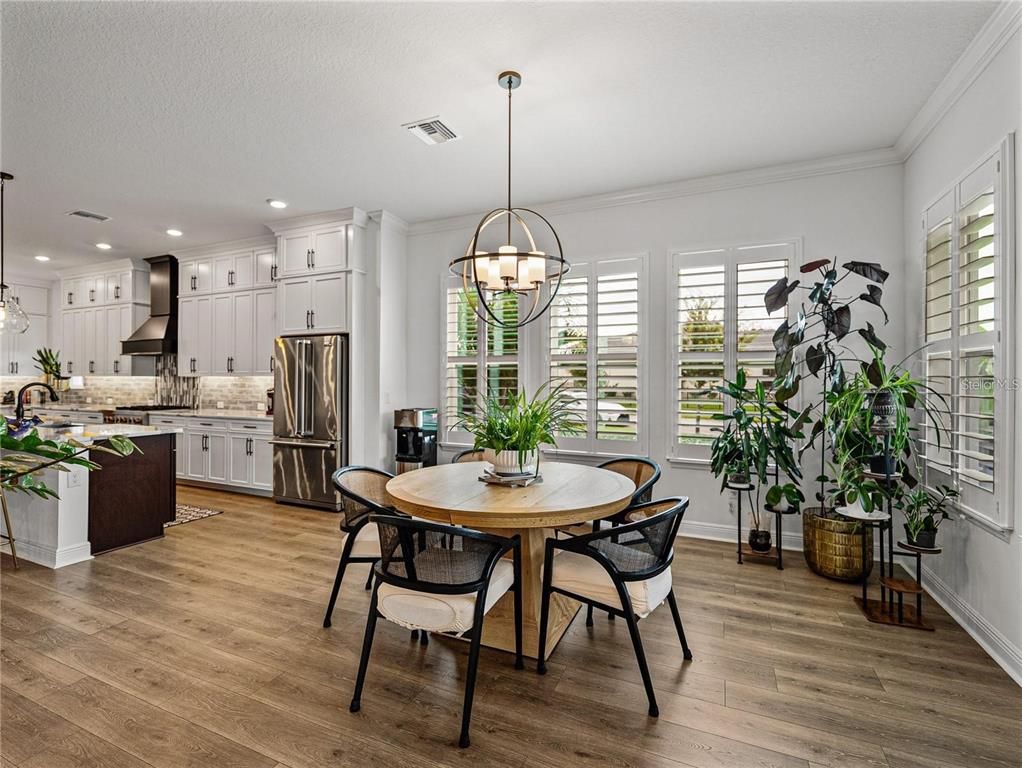 Chandelier, Dining room, Interior, Kitchen, Pendant Lights, Recessed Lighting, Stainless Steel Appliances, Wood Texture Flooring