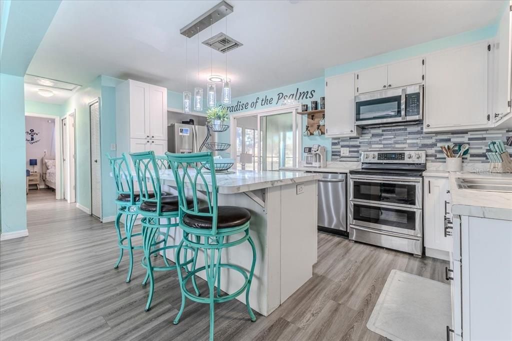 Dining room, Interior, Kitchen, Pendant Lights, Stainless Steel Appliances, Wood Texture Flooring