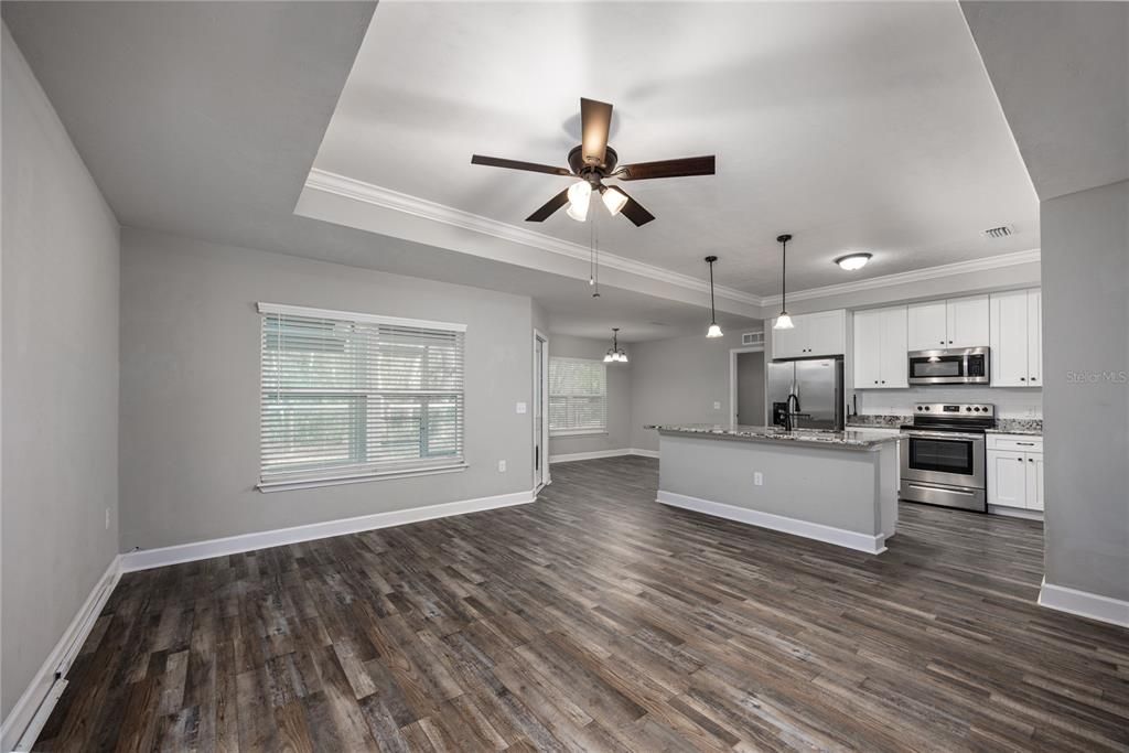 Empty room, Interior, Kitchen, Pendant Lights, Stainless Steel Appliances, Wood Texture Flooring