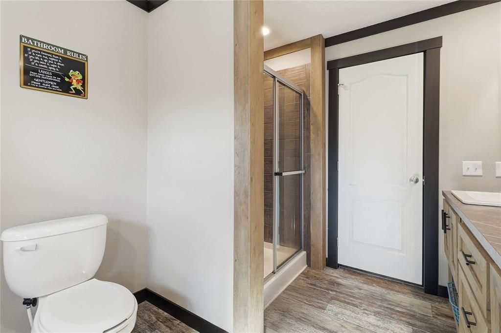 Bathroom, Glass Shower, Interior, Recessed Lighting, Tile Countertops, Wood Texture Flooring