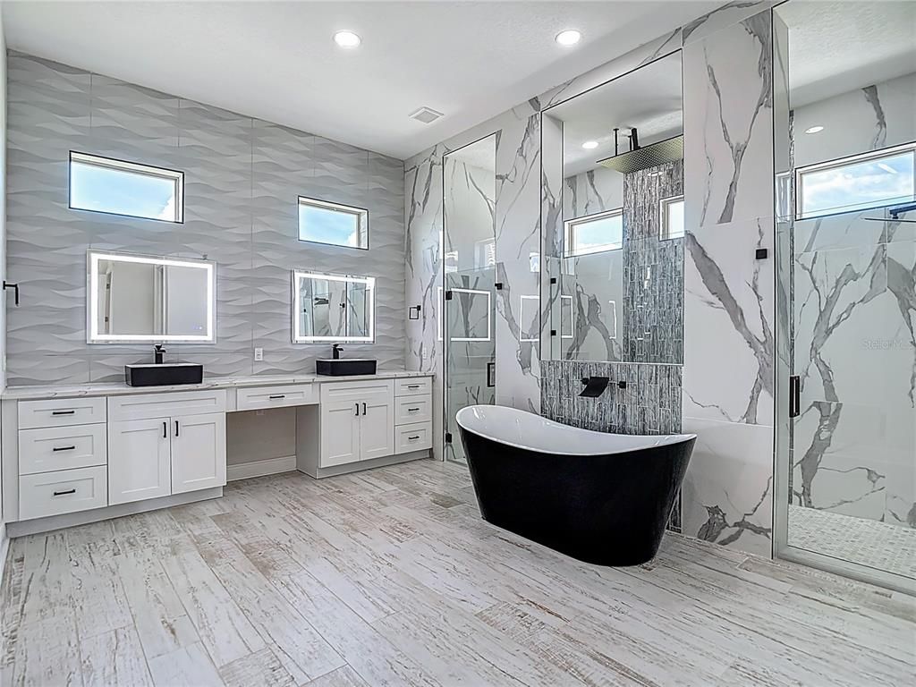 Bathroom, Dual Sink Vanities, Free Standing Baths, Interior, Marble Walls, Recessed Lighting, Wood Texture Flooring