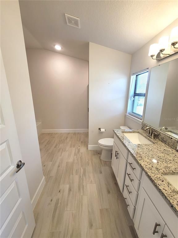 Bathroom, Dual Sink Vanities, Interior, Recessed Lighting, Wood Texture Flooring
