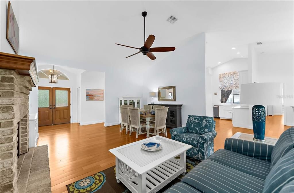 Dining room, Fireplace, Interior, Living room, Recessed Lighting, Stone Walls, Wood Texture Flooring