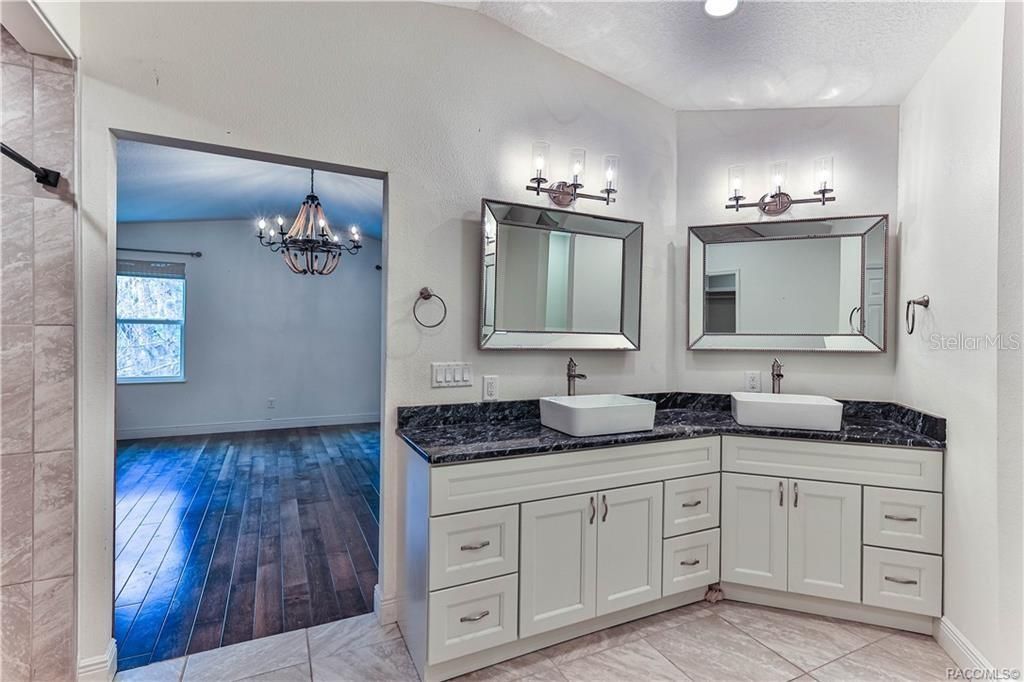 Bathroom, Chandelier, Dual Sink Vanities, Interior, Wood Texture Flooring
