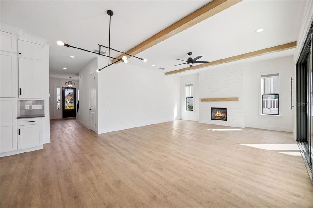 Empty room, Fireplace, Interior, Pendant Lights, Recessed Lighting, Wooden Beams, Wood Texture Flooring