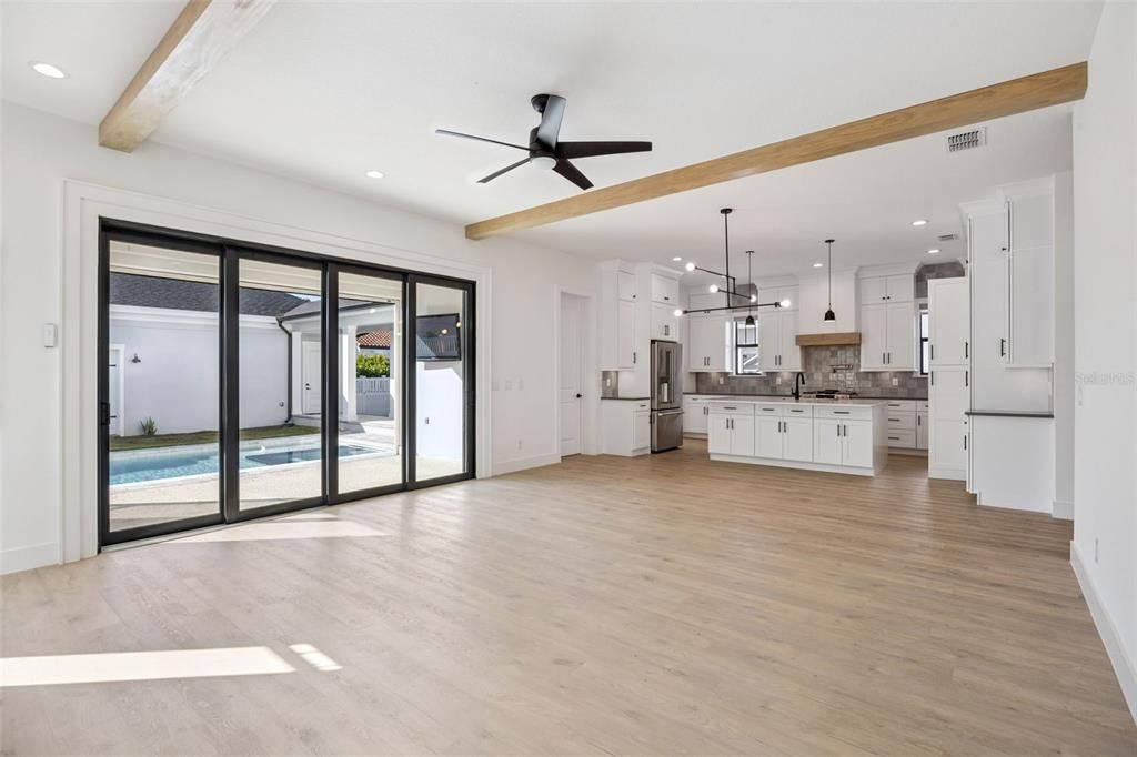 Empty room, Interior, Kitchen, Pendant Lights, Recessed Lighting, Stainless Steel Appliances, Wooden Beams, Wood Texture Flooring