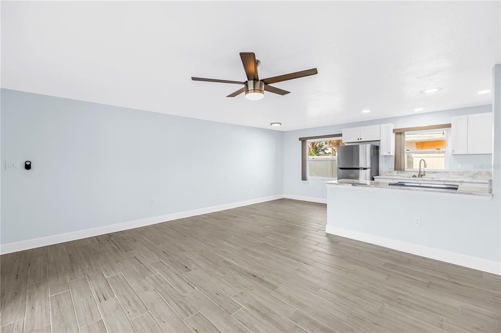 Empty room, Interior, Kitchen, Recessed Lighting, Stainless Steel Appliances, Wood Texture Flooring