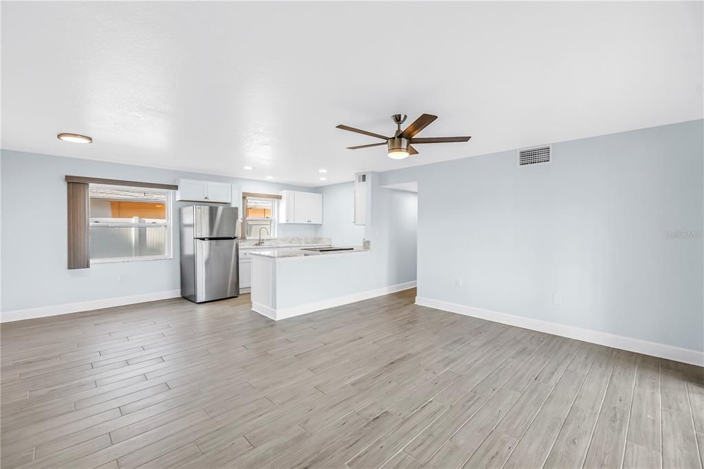 Empty room, Interior, Kitchen, Recessed Lighting, Stainless Steel Appliances, Wood Texture Flooring