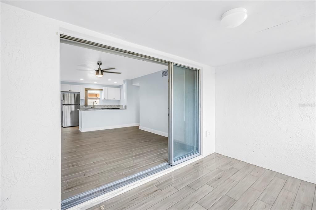 Empty room, Interior, Kitchen, Recessed Lighting, Stainless Steel Appliances, Wood Texture Flooring