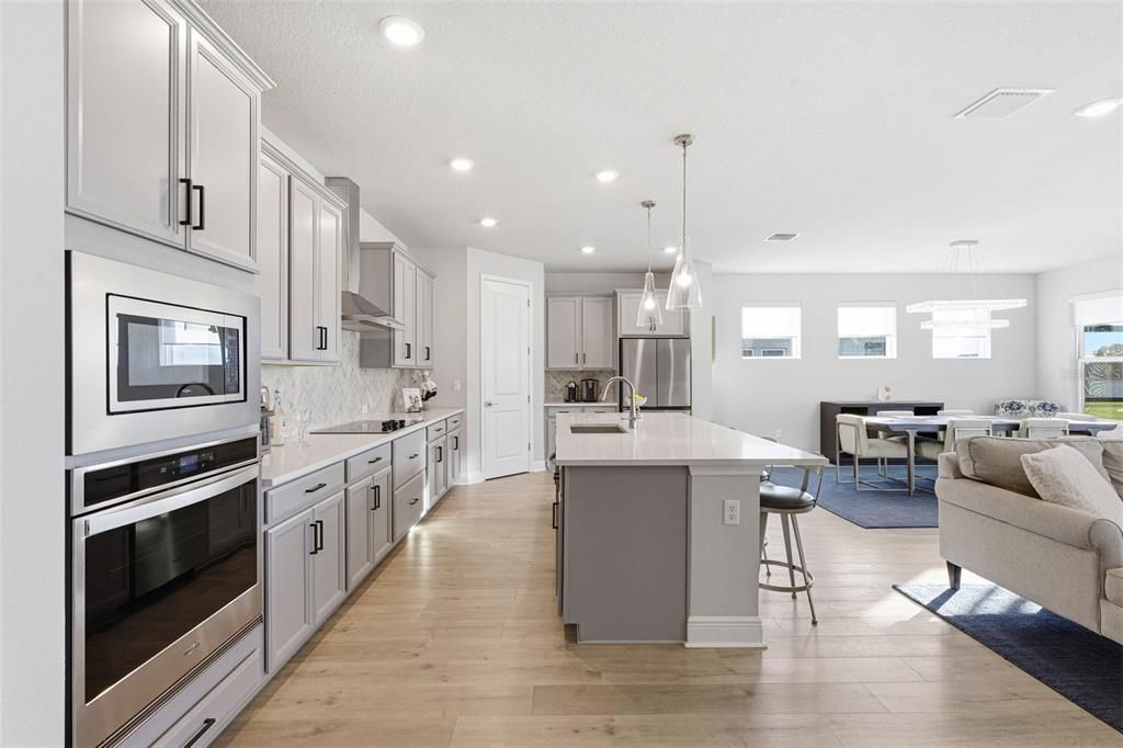 Dining room, Interior, Kitchen, Pendant Lights, Recessed Lighting, Stainless Steel Appliances, Wood Texture Flooring
