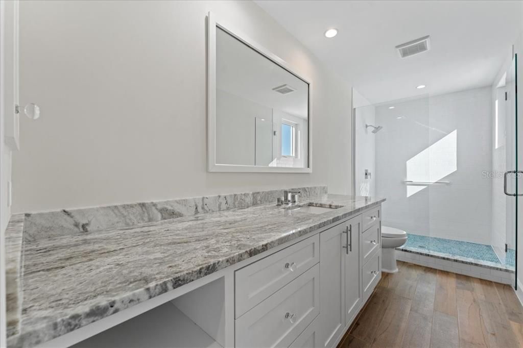 Bathroom, Dual Sink Vanities, Glass Shower, Interior, Recessed Lighting, Wood Texture Flooring