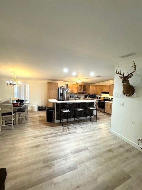 Chandelier, Dining room, Interior, Kitchen, Recessed Lighting, Stainless Steel Appliances, Wood Texture Flooring