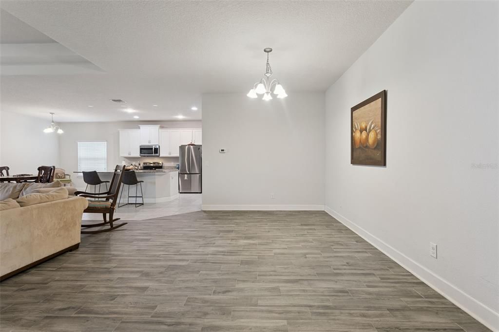 Chandelier, Dining room, Interior, Kitchen, Living room, Pendant Lights, Recessed Lighting, Stainless Steel Appliances, Wood Texture Flooring