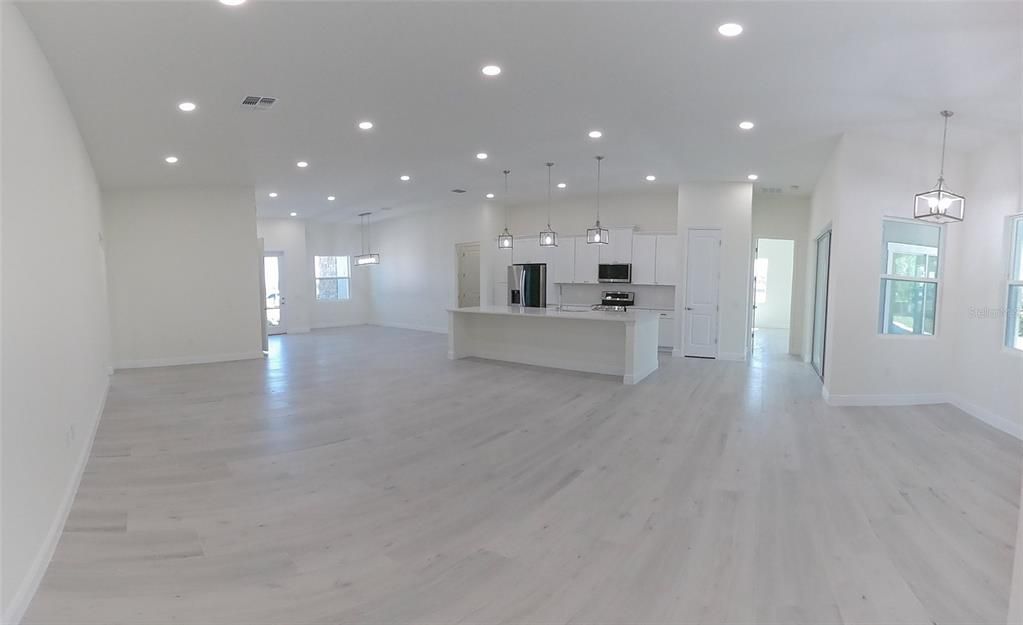 Empty room, Interior, Kitchen, Pendant Lights, Recessed Lighting, Stainless Steel Appliances, Wood Texture Flooring