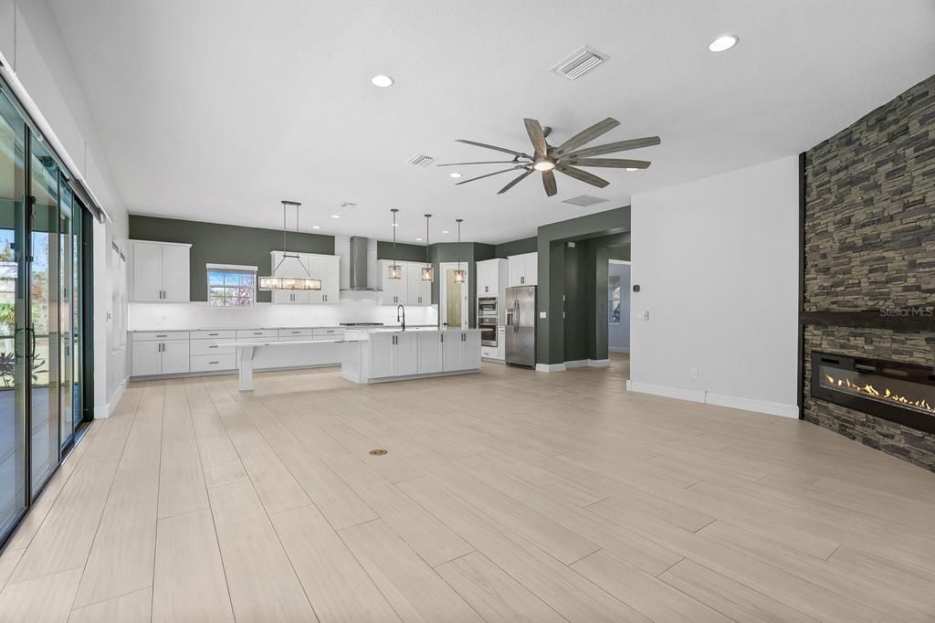 Empty room, Fireplace, Interior, Kitchen, Pendant Lights, Recessed Lighting, Wood Texture Flooring