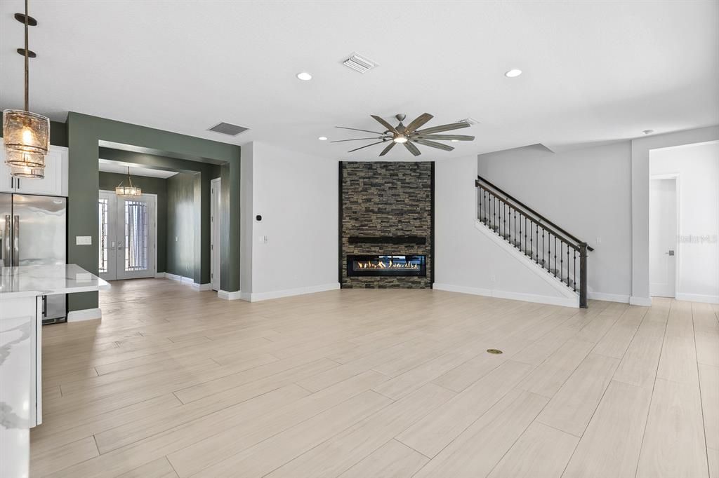 Empty room, Fireplace, Interior, Pendant Lights, Recessed Lighting, Stone Walls, Wood Texture Flooring