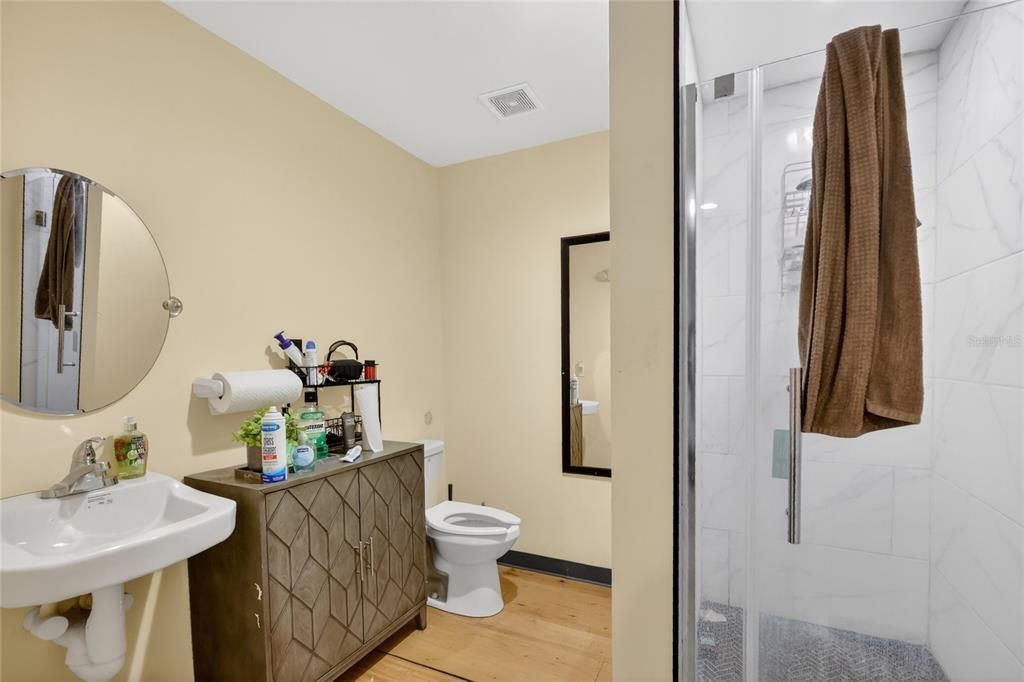 Bathroom, Glass Shower, Interior, Marble Walls, Wood Texture Flooring