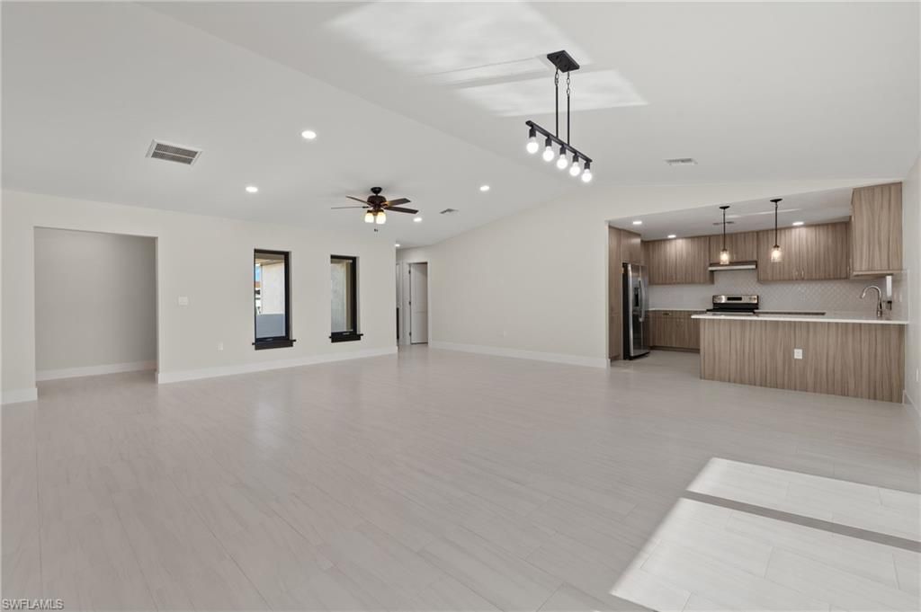 Empty room, Interior, Kitchen, Pendant Lights, Recessed Lighting, Stainless Steel Appliances, Wood Texture Flooring