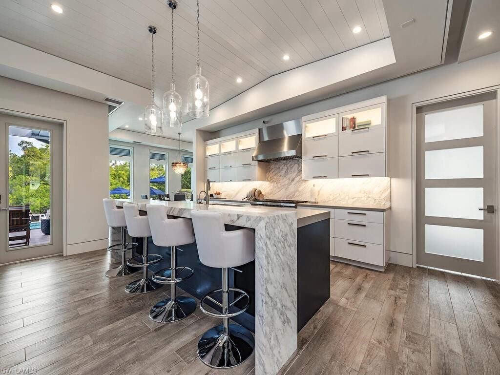 Interior, Kitchen, Marble Walls, Pendant Lights, Recessed Lighting, Stainless Steel Appliances, Wood Texture Flooring