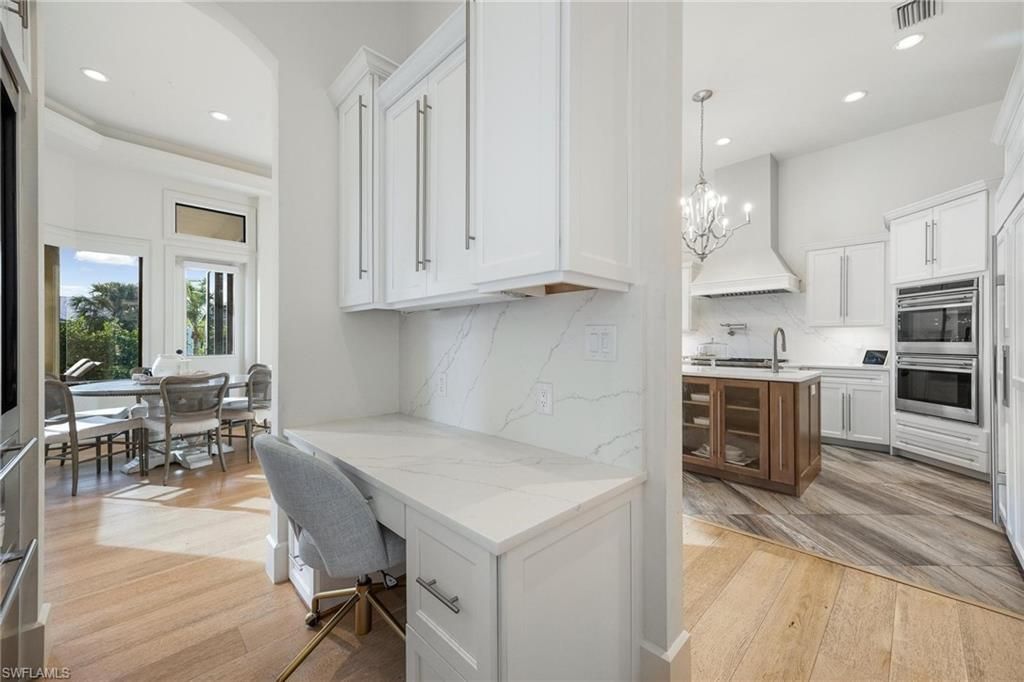 Chandelier, Dining room, Interior, Kitchen, Marble Walls, Recessed Lighting, Stainless Steel Appliances, Wood Texture Flooring