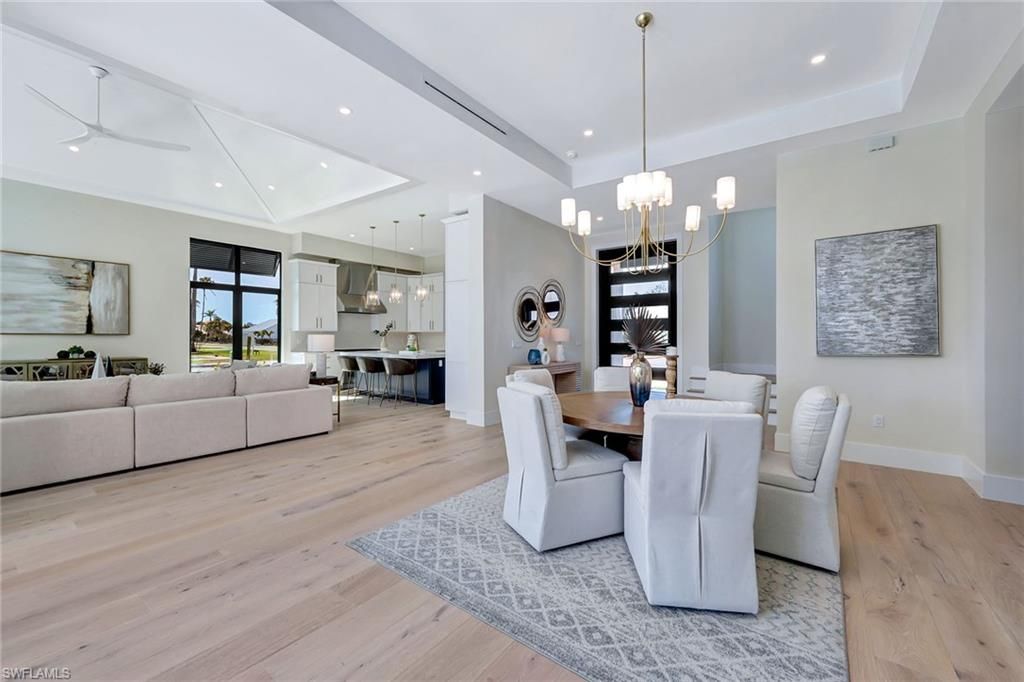 Chandelier, Dining room, Interior, Kitchen, Living room, Pendant Lights, Recessed Lighting, Stainless Steel Appliances, Wood Texture Flooring