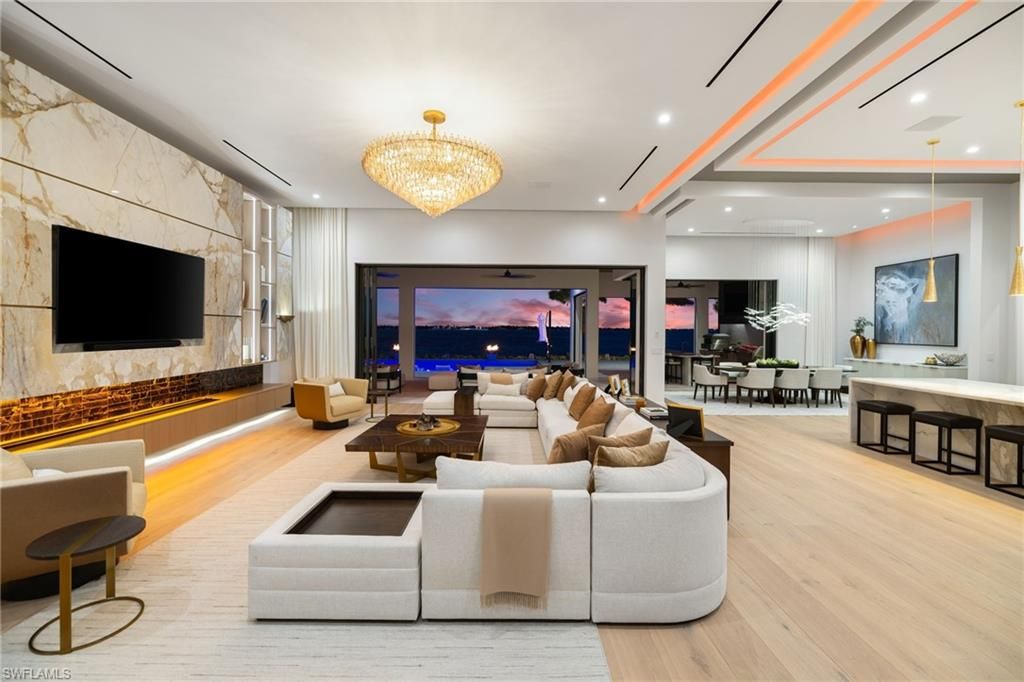 Chandelier, Dining room, Fireplace, Interior, Living room, Marble Walls, Recessed Lighting, Wood Texture Flooring