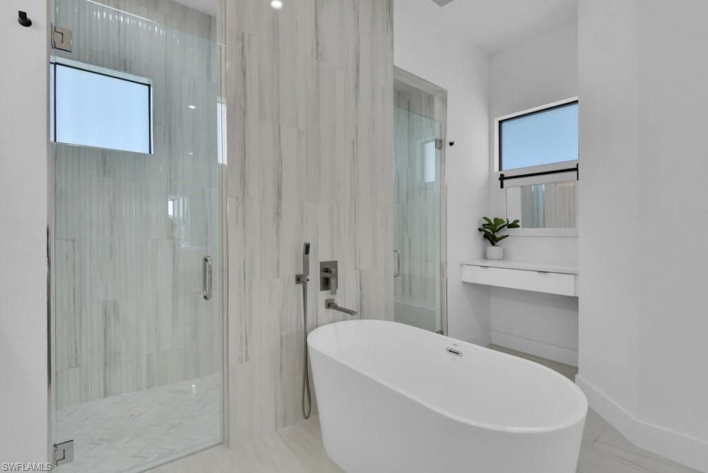 Bathroom, Free Standing Baths, Glass Shower, Interior, Marble, Marble Walls, Recessed Lighting