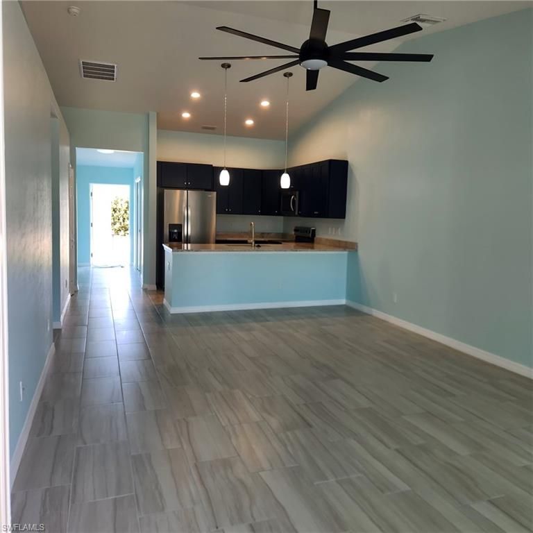 Empty room, Interior, Kitchen, Pendant Lights, Recessed Lighting, Stainless Steel Appliances, Wood Texture Flooring