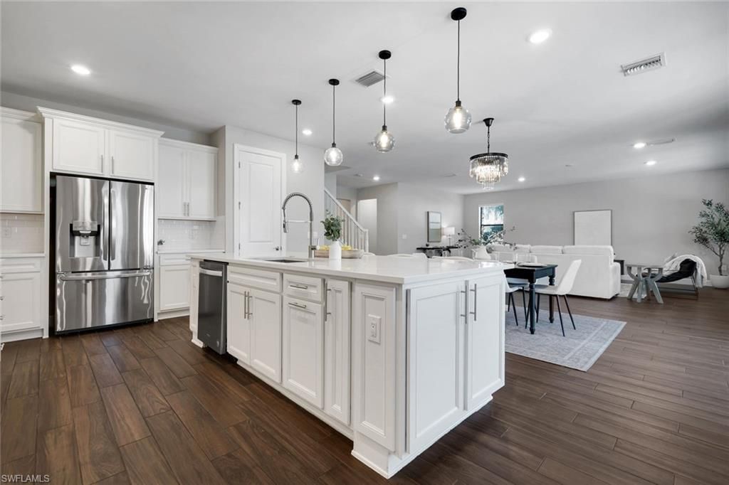 Chandelier, Dining room, Interior, Kitchen, Pendant Lights, Recessed Lighting, Stainless Steel Appliances, Wood Texture Flooring