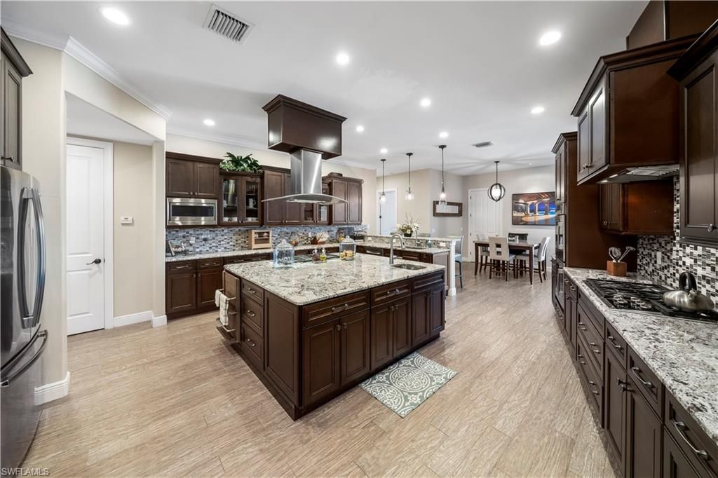 Dining room, Interior, Kitchen, Pendant Lights, Recessed Lighting, Stainless Steel Appliances, Wood Texture Flooring