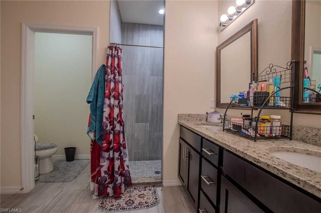 Bathroom, Dual Sink Vanities, Interior, Recessed Lighting, Wood Texture Flooring