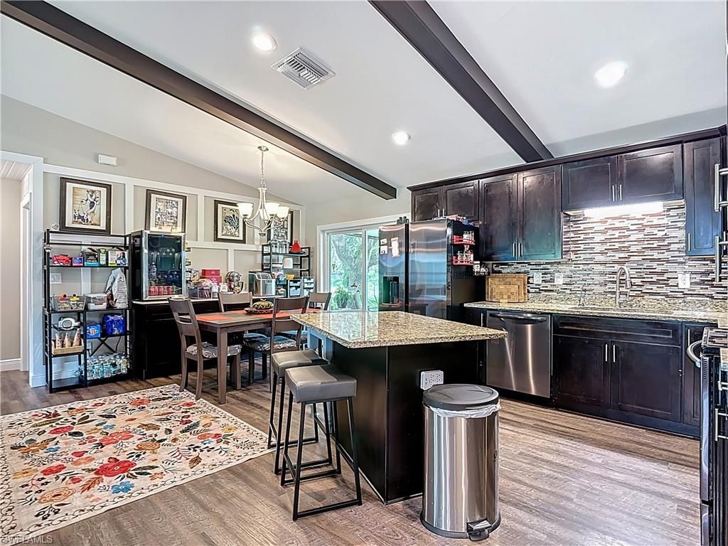 Chandelier, Dining room, Interior, Kitchen, Pendant Lights, Recessed Lighting, Stainless Steel Appliances, Wood Texture Flooring