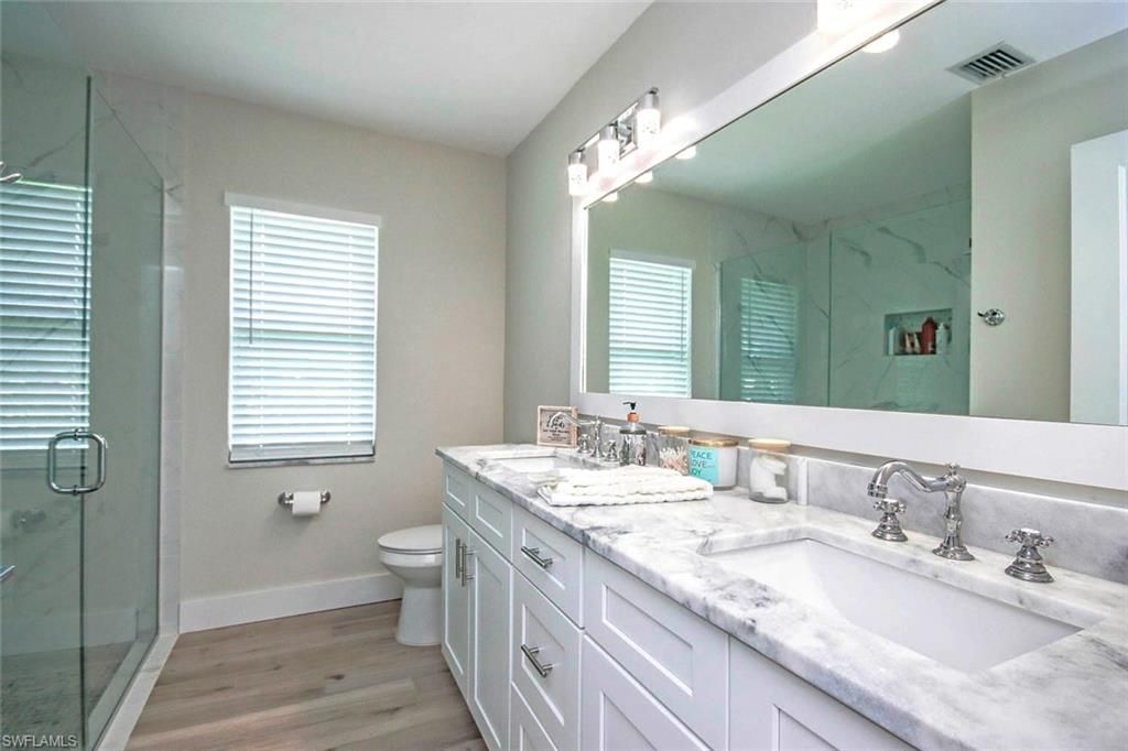Bathroom, Dual Sink Vanities, Glass Shower, Interior, Marble Walls, Wood Texture Flooring