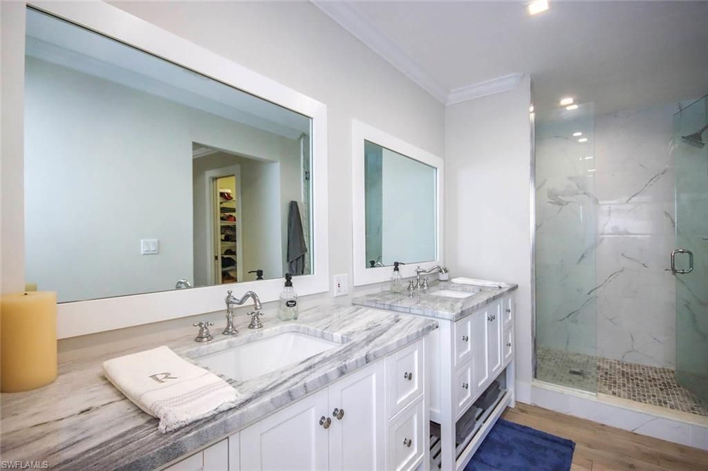 Bathroom, Dual Sink Vanities, Glass Shower, Interior, Marble Walls, Recessed Lighting, Wood Texture Flooring