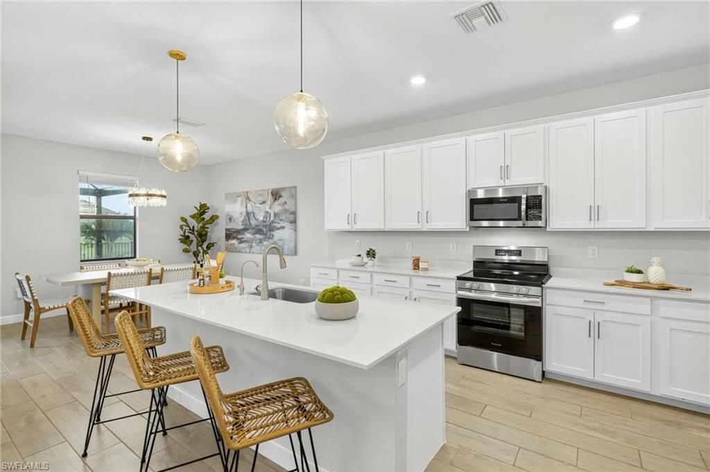 Dining room, Interior, Kitchen, Pendant Lights, Recessed Lighting, Stainless Steel Appliances, Wood Texture Flooring