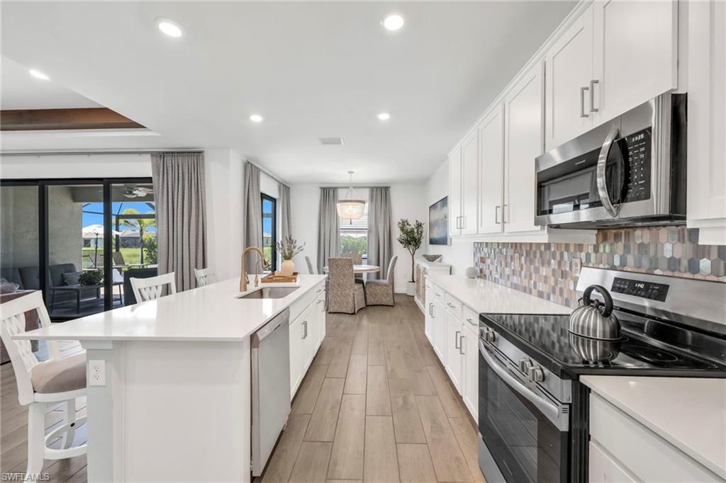 Dining room, Interior, Kitchen, Pendant Lights, Recessed Lighting, Stainless Steel Appliances, Wood Texture Flooring