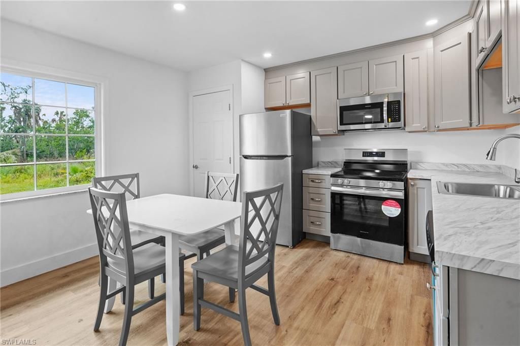 Dining room, Interior, Kitchen, Recessed Lighting, Stainless Steel Appliances, Wood Texture Flooring