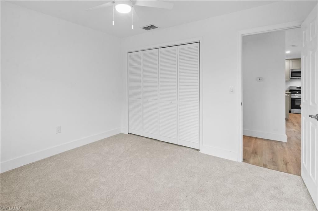 Empty room, Interior, Kitchen, Recessed Lighting, Stainless Steel Appliances, Wood Texture Flooring