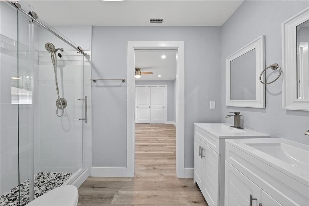 Bathroom, Dual Sink Vanities, Glass Shower, Interior, Recessed Lighting, Wood Texture Flooring