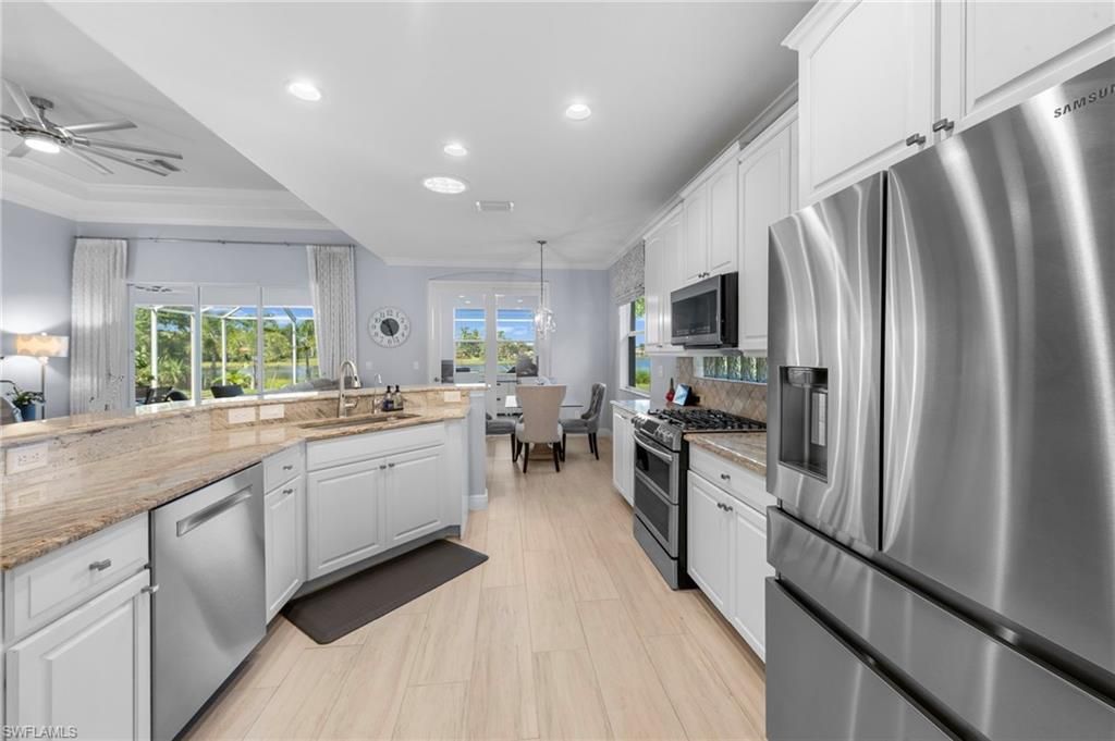 Dining room, Interior, Kitchen, Pendant Lights, Recessed Lighting, Stainless Steel Appliances, Wood Texture Flooring