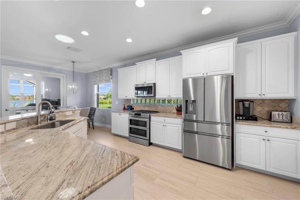 Dining room, Interior, Kitchen, Pendant Lights, Recessed Lighting, Stainless Steel Appliances, Water, Wood Texture Flooring
