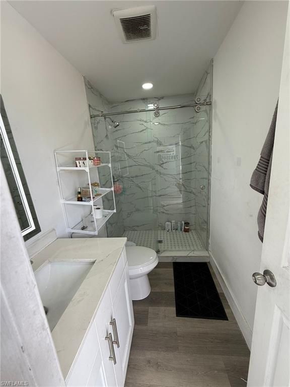 Bathroom, Glass Shower, Interior, Marble Walls, Recessed Lighting, Wood Texture Flooring