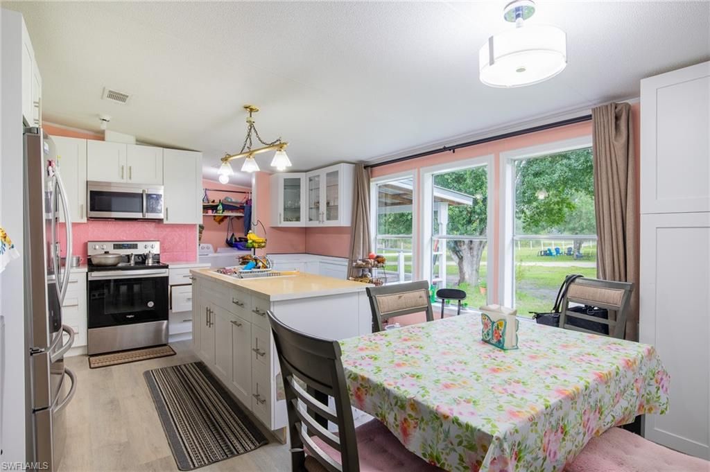 Dining room, Interior, Kitchen, Pendant Lights, Stainless Steel Appliances, Wood Texture Flooring
