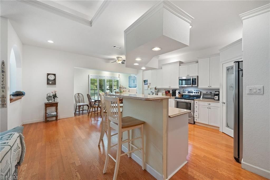 Dining room, Interior, Kitchen, Recessed Lighting, Stainless Steel Appliances, Wood Texture Flooring