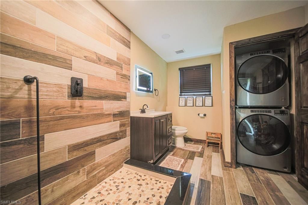 Bathroom, Interior, Utility Closets, Washer, Wood Texture Flooring, Wooden Walls