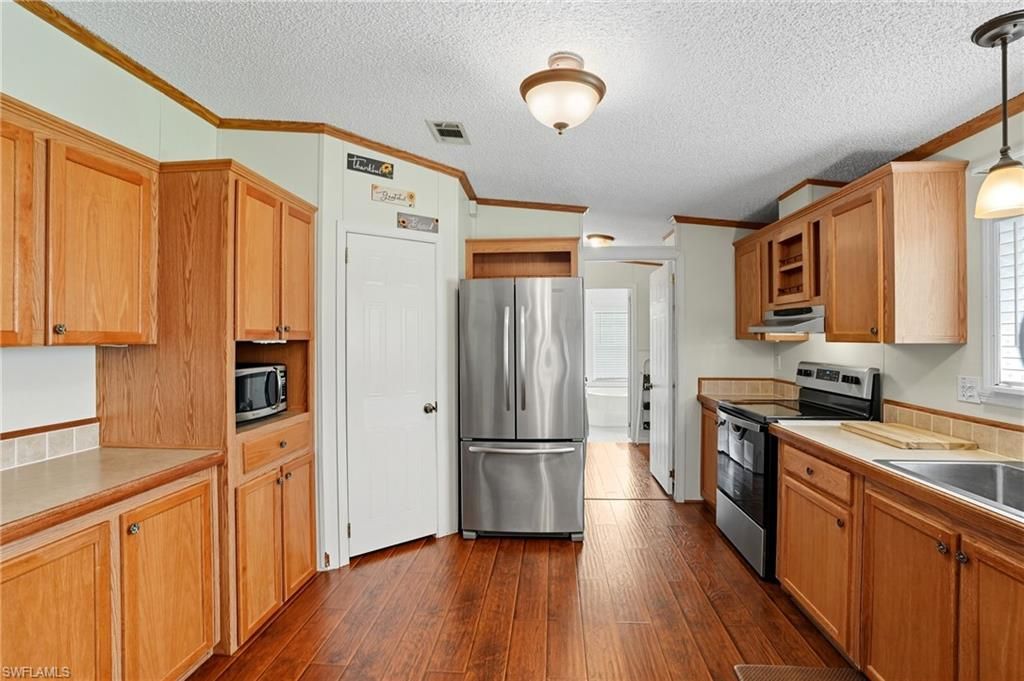 Interior, Kitchen, Pendant Lights, Stainless Steel Appliances, Tile Countertops, Wood Texture Flooring