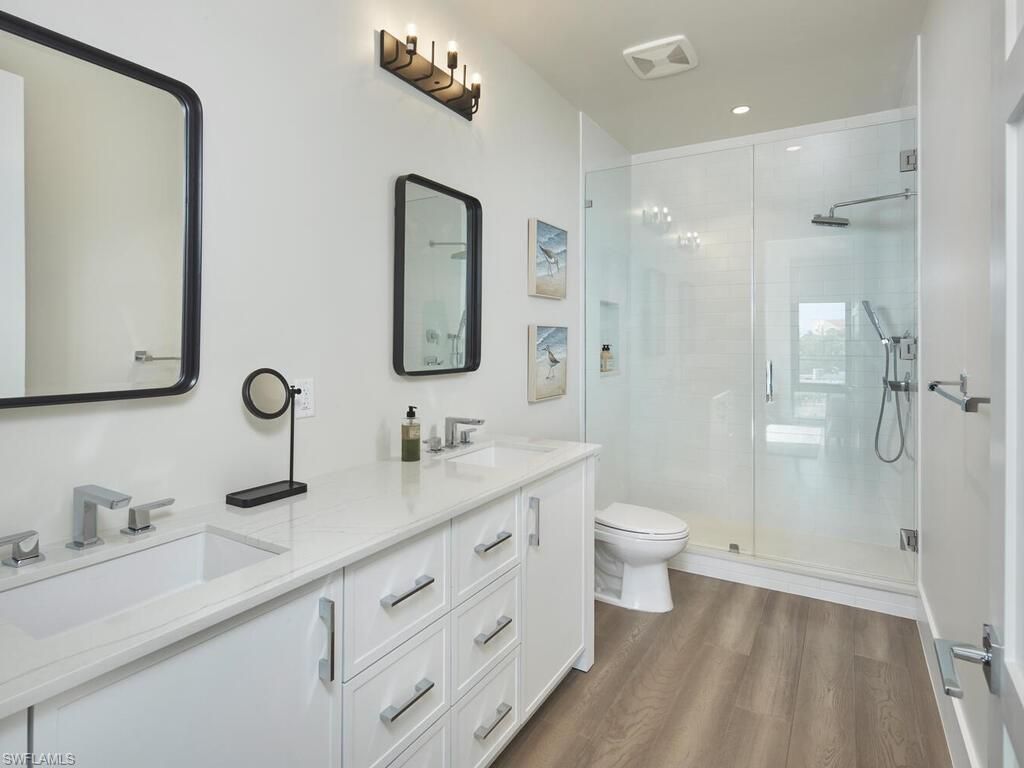 Bathroom, Dual Sink Vanities, Glass Shower, Interior, Recessed Lighting, Wood Texture Flooring