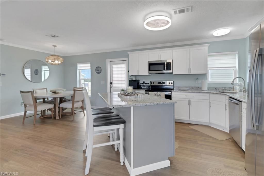 Dining room, Interior, Kitchen, Pendant Lights, Stainless Steel Appliances, Wood Texture Flooring