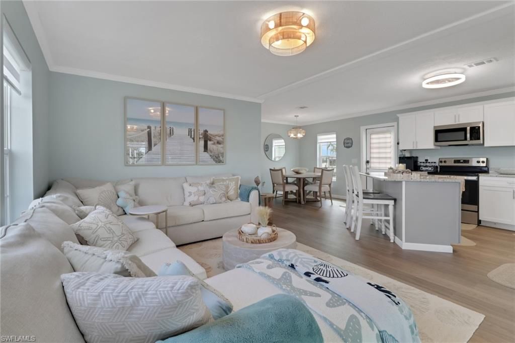 Chandelier, Dining room, Interior, Kitchen, Living room, Stainless Steel Appliances, Wood Texture Flooring